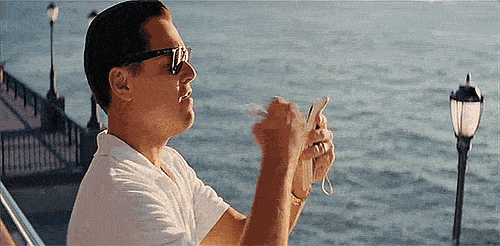 Wolf of Wall Street throwing money gif